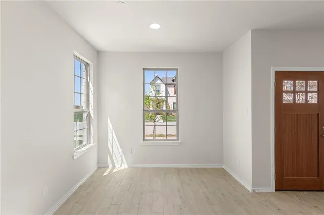 an empty room with windows and closet