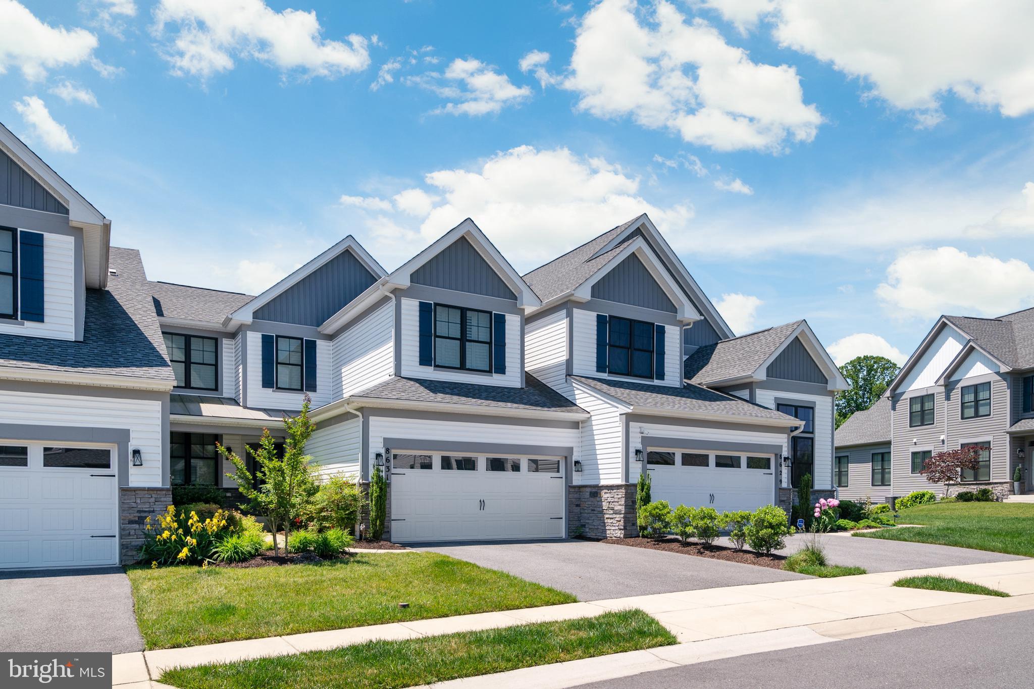 8631 St Anthony Drive Severn, MD 21144 - Photo 1 of 41 a front view of a house with a yard and garage