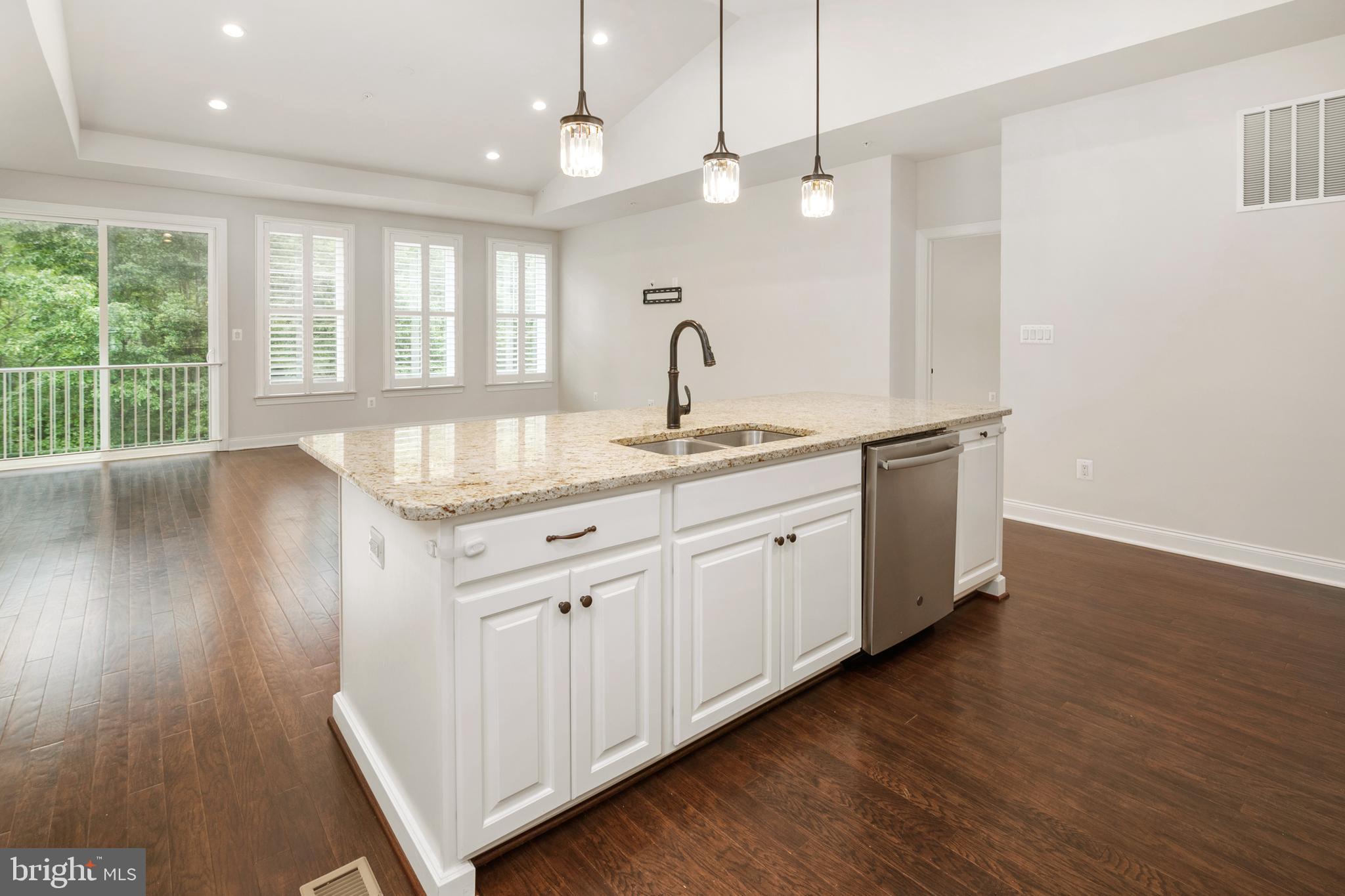 8631 St Anthony Drive Severn, MD 21144 - Photo 15 of 41 a kitchen with a sink cabinets and wooden floor
