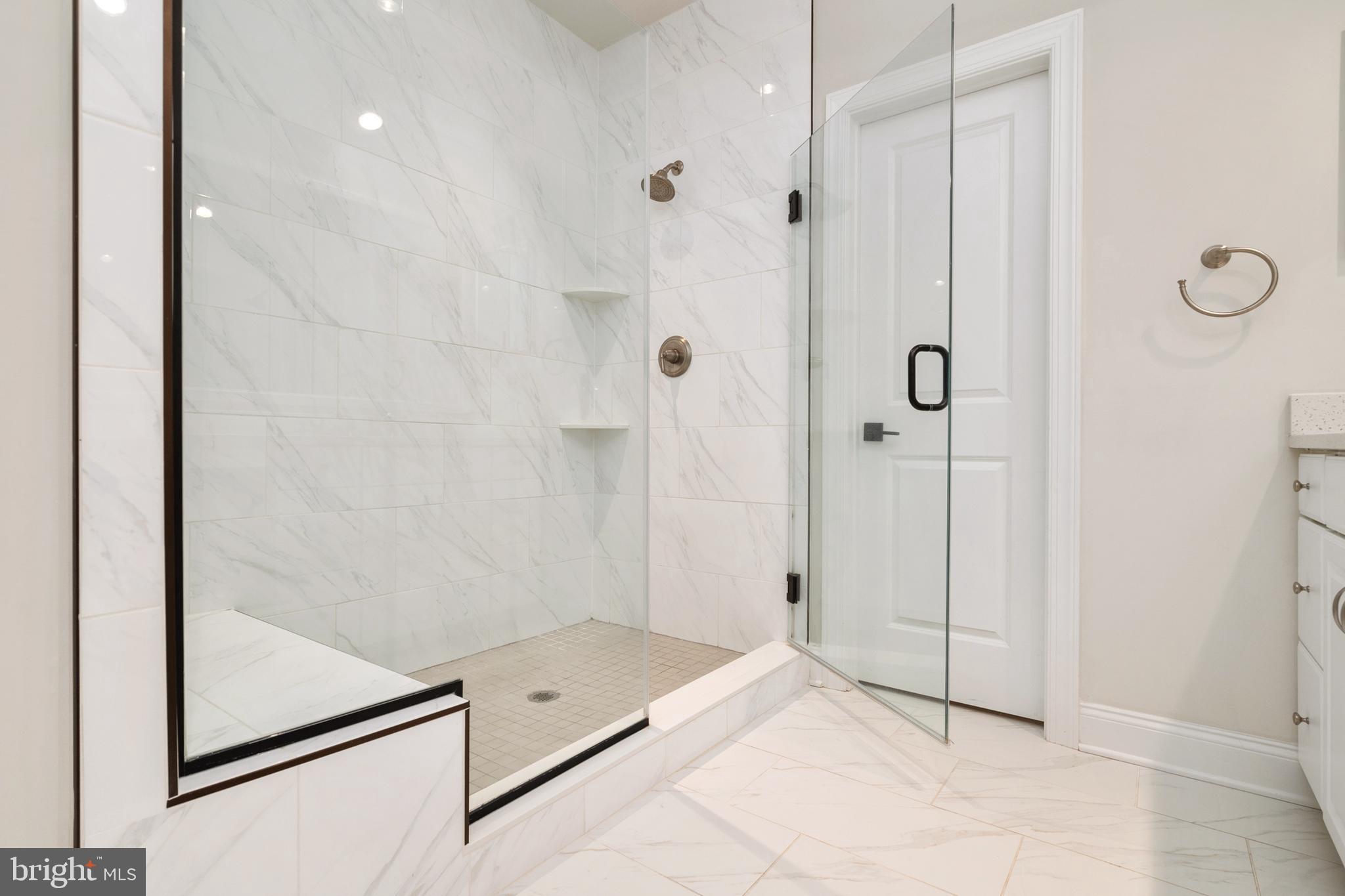 8631 St Anthony Drive Severn, MD 21144 - Photo 22 of 41 a bathroom with a glass shower door