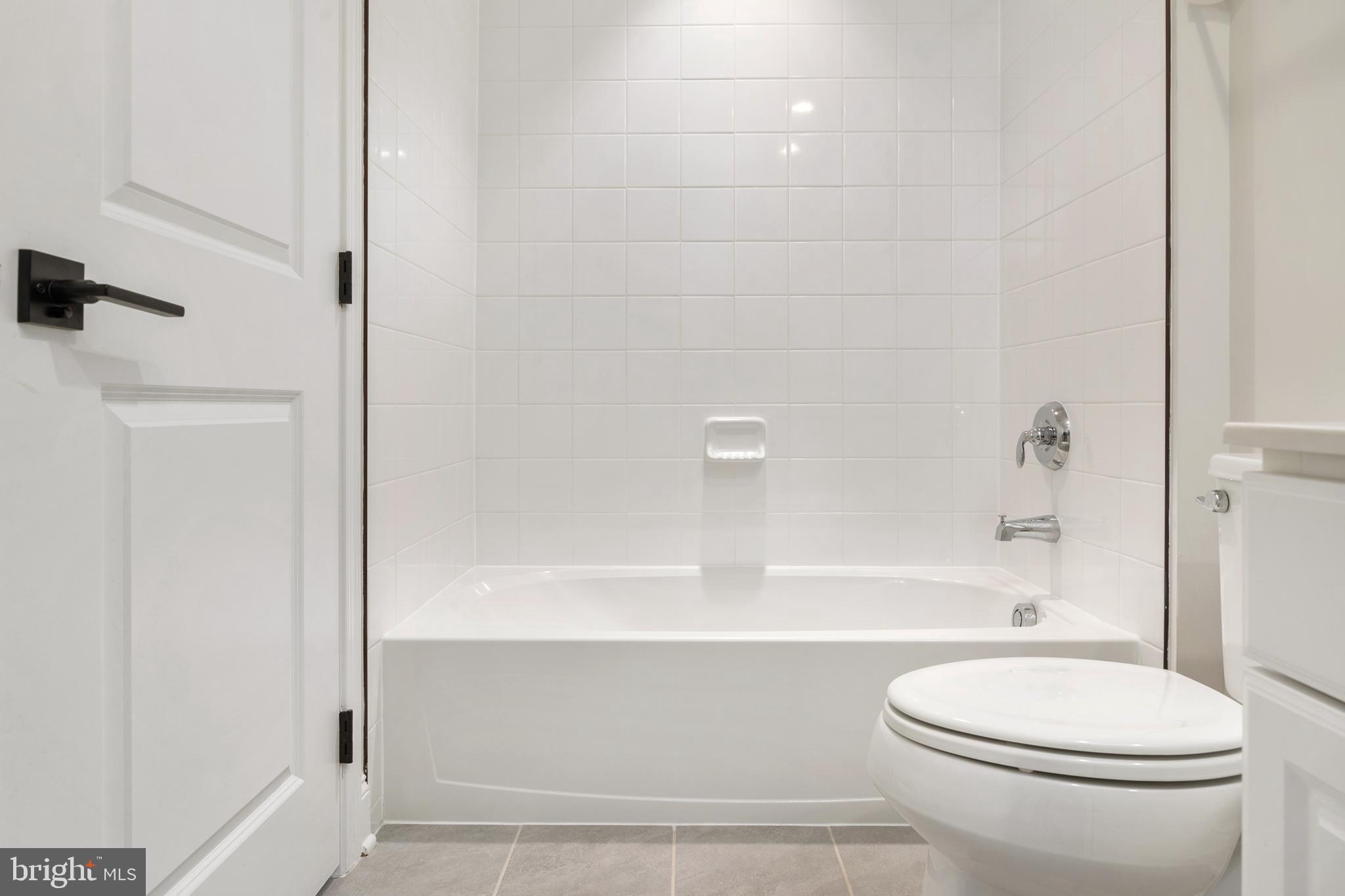 8631 St Anthony Drive Severn, MD 21144 - Photo 27 of 41 a bathroom with a toilet and a bathtub