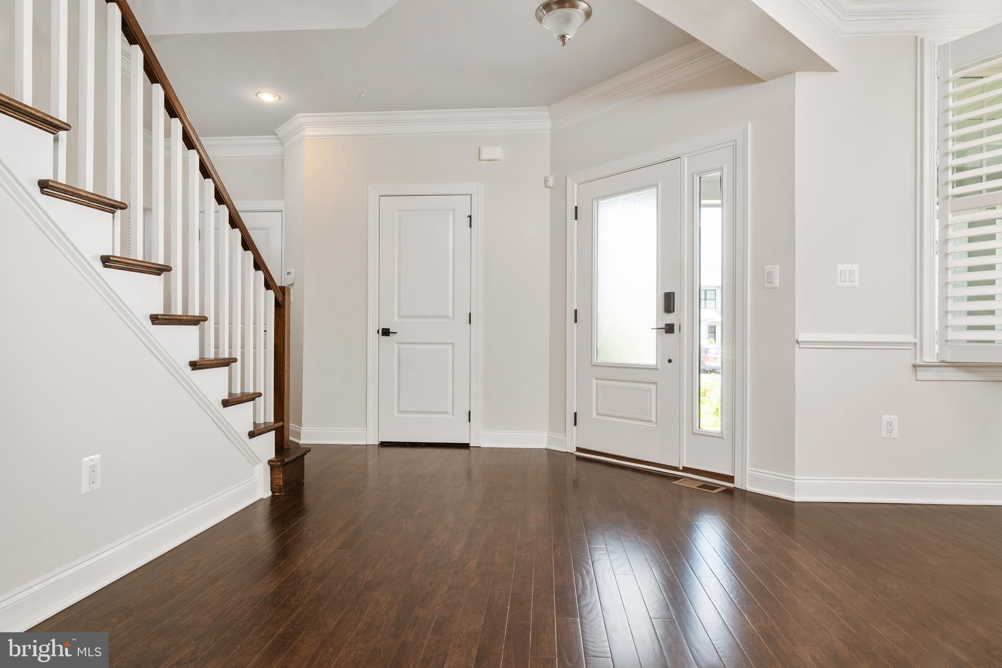 8631 St Anthony Drive Severn, MD 21144 - Photo 7 of 41 a view of entryway with wooden floor and stairs