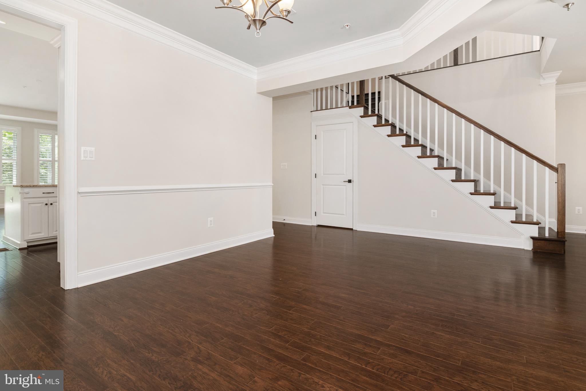 8631 St Anthony Drive Severn, MD 21144 - Photo 8 of 41 a view of an empty room with wooden floor