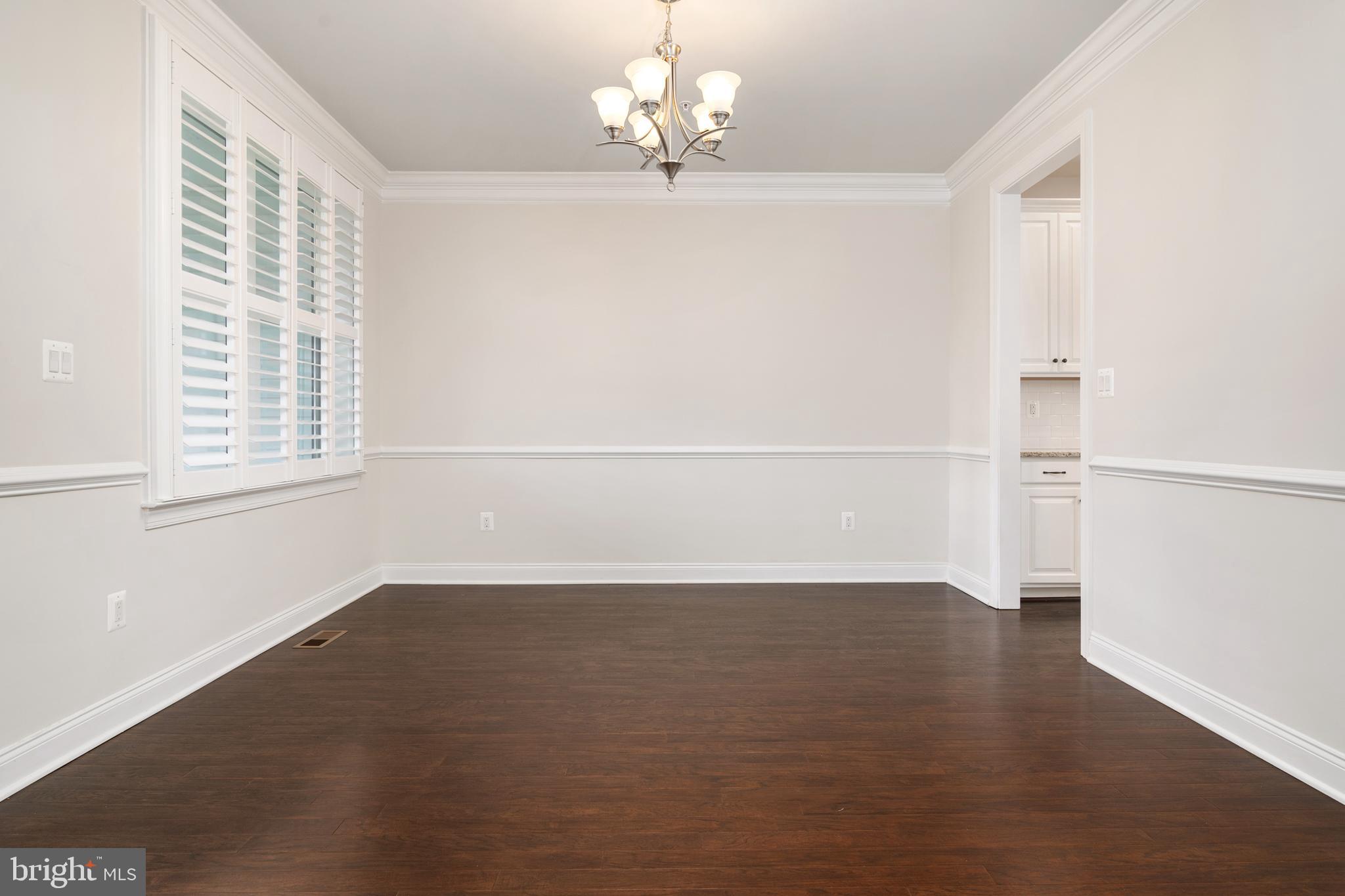 8631 St Anthony Drive Severn, MD 21144 - Photo 9 of 41 wooden floor in an empty room with a window