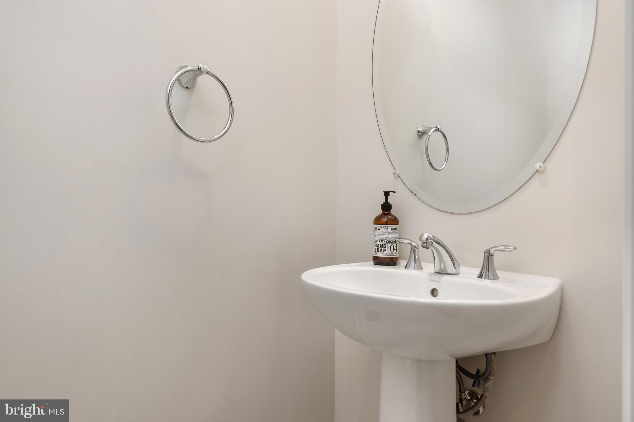 8631 St Anthony Drive Severn, MD 21144 - Photo 10 of 41 a bathroom with a sink and a mirror