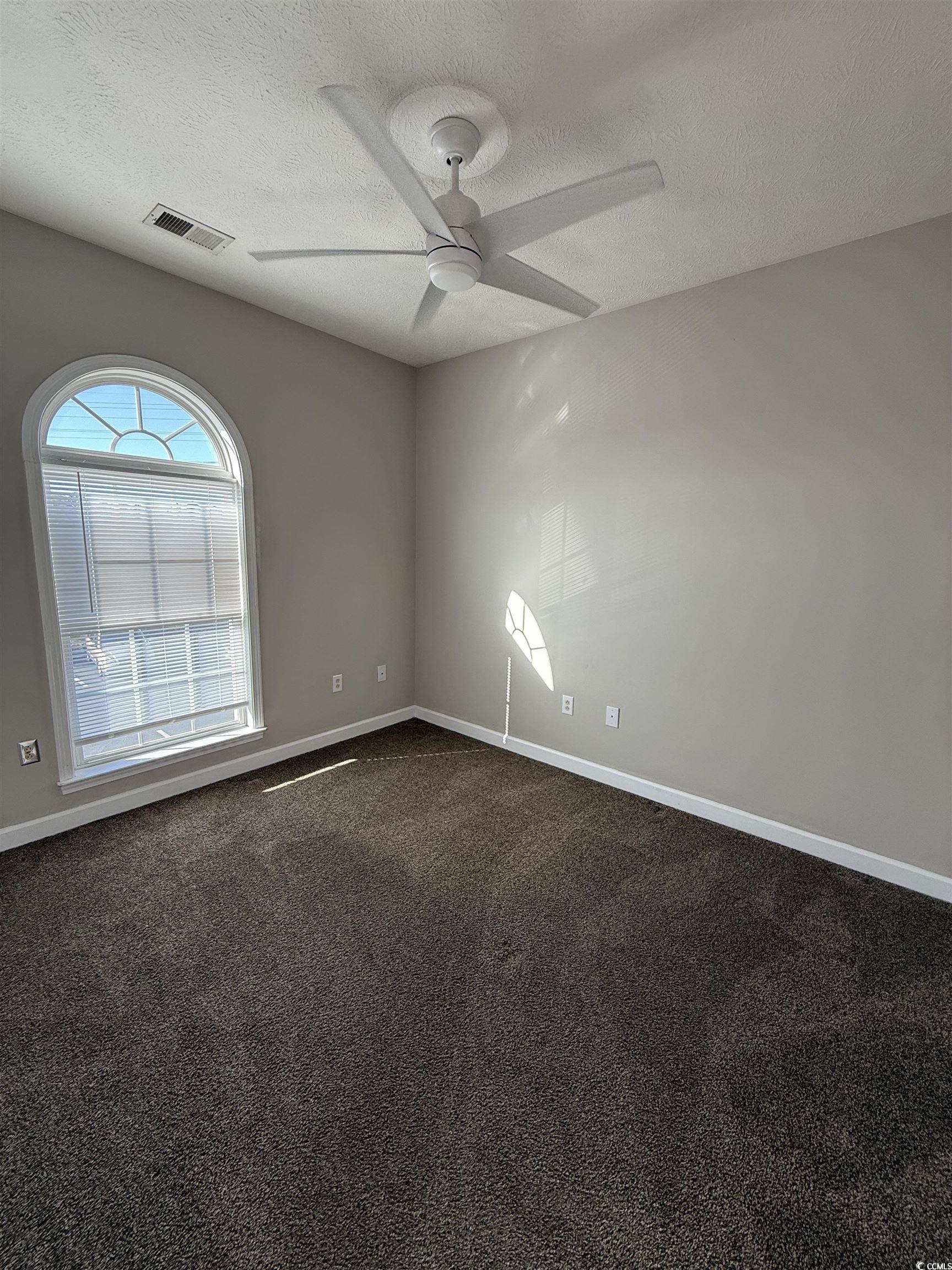 213 Wando River Road Myrtle Beach, SC 29579 - Photo 7 of 16 Unfurnished room featuring dark colored carpet, vi