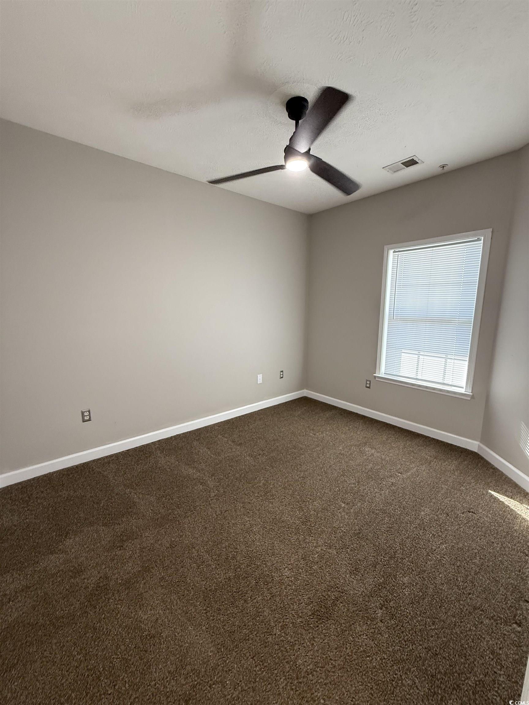 213 Wando River Road Myrtle Beach, SC 29579 - Photo 9 of 16 Empty room featuring dark colored carpet, visible