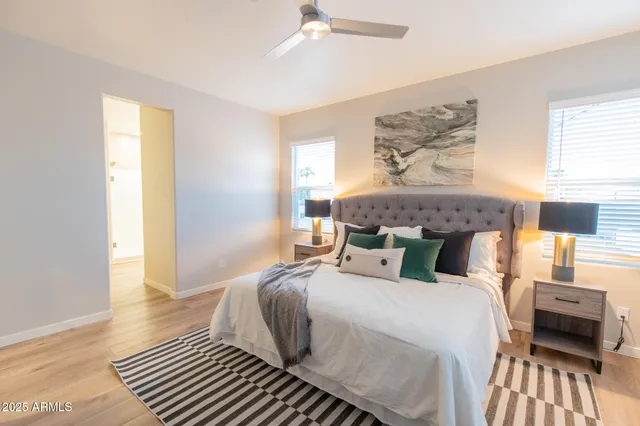 a bedroom with a bed wooden floor and window