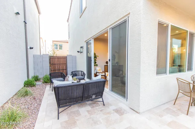a dining room with furniture a rug and a floor to ceiling window