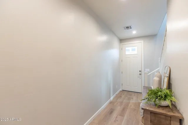 a view of entryway and hall with wooden floor