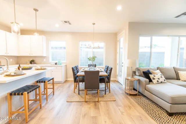 a kitchen with stainless steel appliances a sink a stove a refrigerator and cabinets