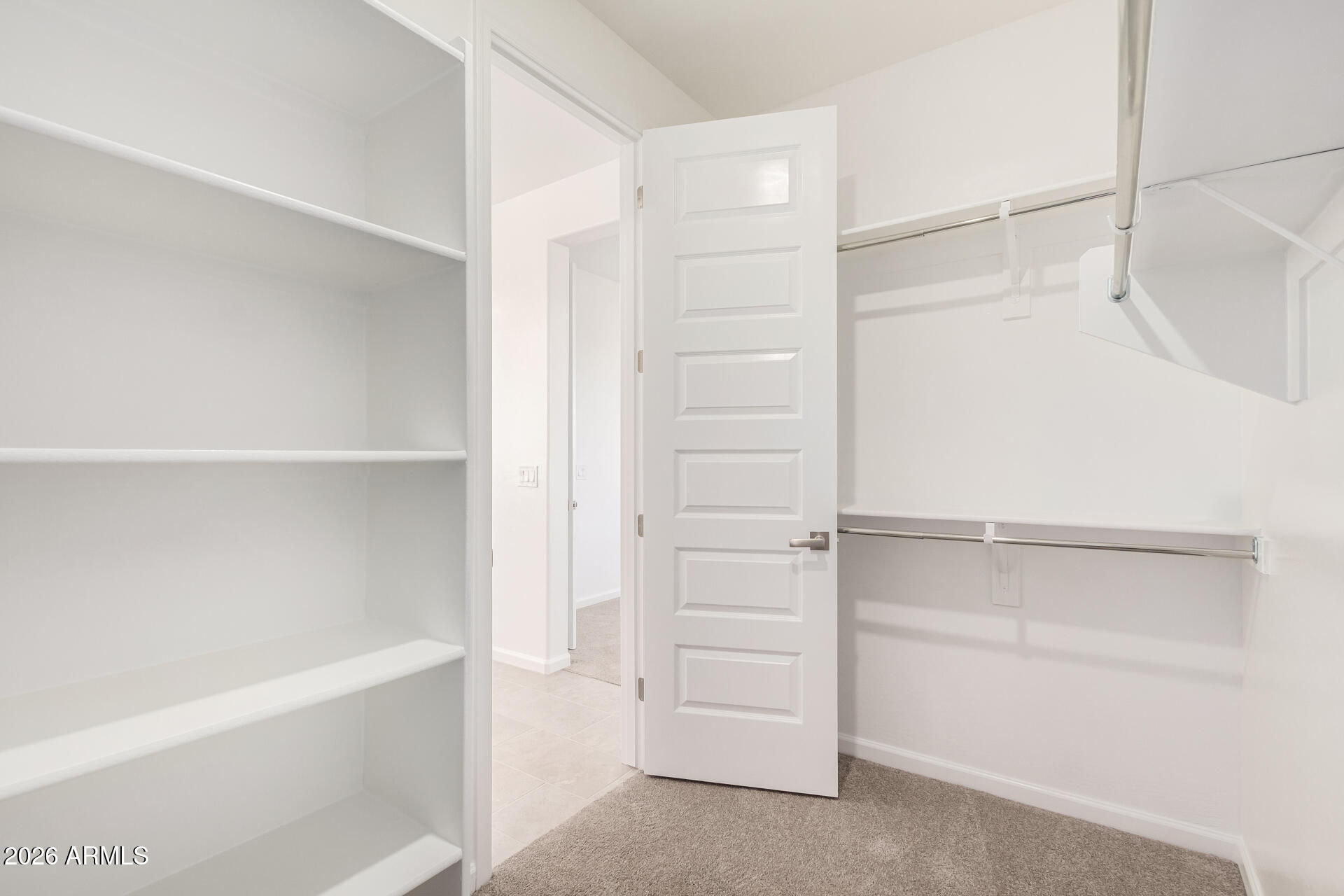 13232 West W Ranch Peoria, AZ 85383 - Photo 11 of 24 a view of walk in closet with empty racks