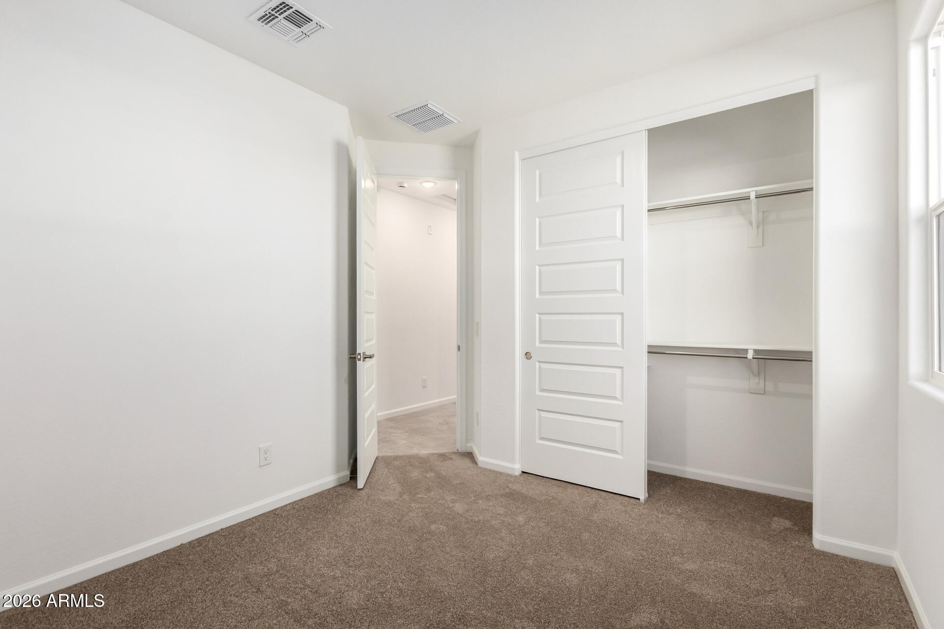 13232 West W Ranch Peoria, AZ 85383 - Photo 16 of 24 a view of an empty walk in closet with empty racks