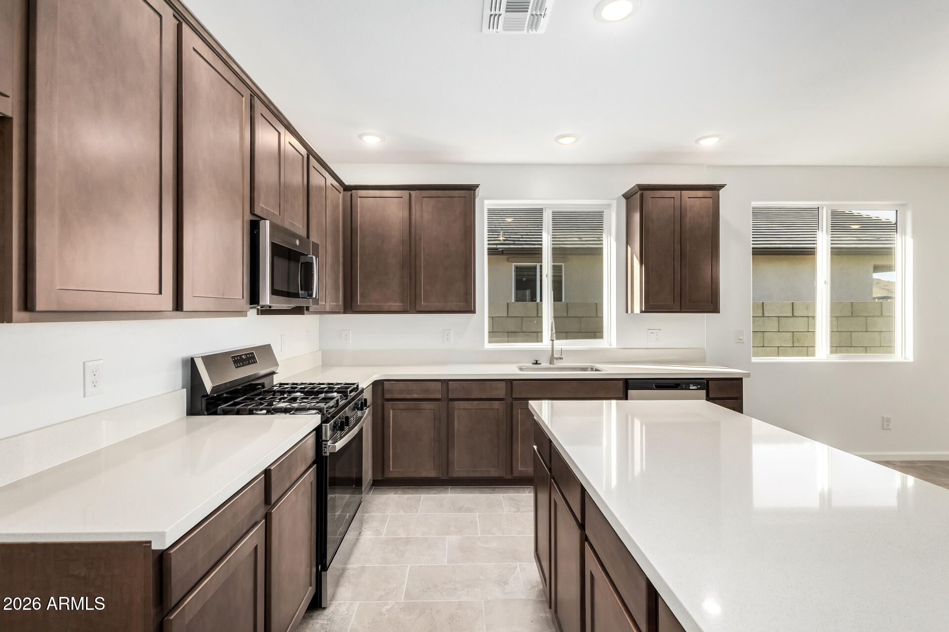 13232 West W Ranch Peoria, AZ 85383 - Photo 6 of 24 a kitchen with stainless steel appliances granite countertop a sink stove and cabinets