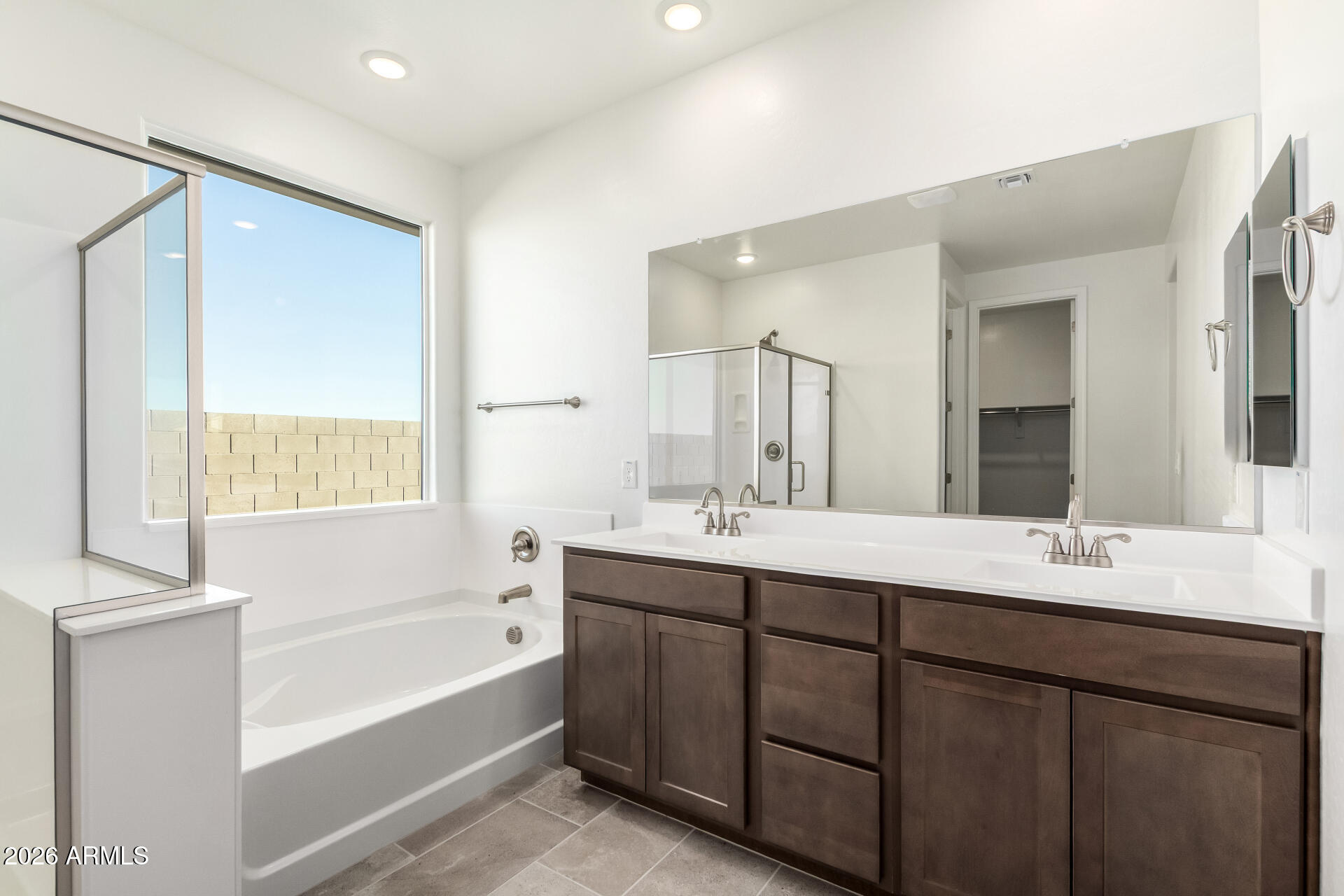 13232 West W Ranch Peoria, AZ 85383 - Photo 9 of 24 a bathroom with a tub sink and mirror