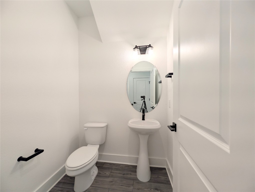 113 Sycamore Pnes Lane Kyle, TX 78640 - Photo 10 of 32 a bathroom with a toilet sink and mirror