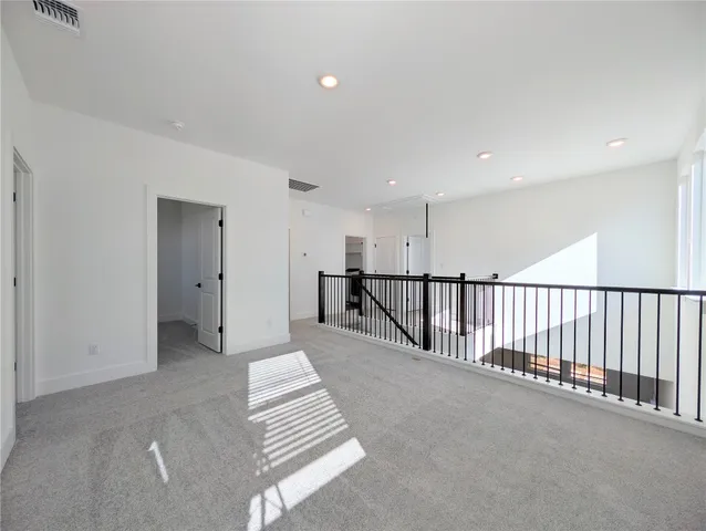 a view of a hallway with stairs