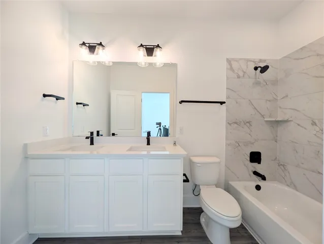 a bathroom with a sink mirror toilet and bathtub