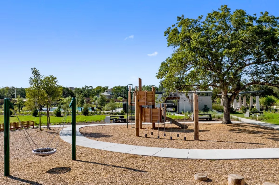 113 Sycamore Pnes Lane Kyle, TX 78640 - Photo 30 of 32 a view of a park with swings
