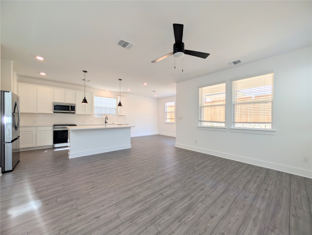113 Sycamore Pnes Lane Kyle, TX 78640 - Photo 4 of 32 a view of kitchen with stainless steel appliances refrigerator stove microwave and cabinets