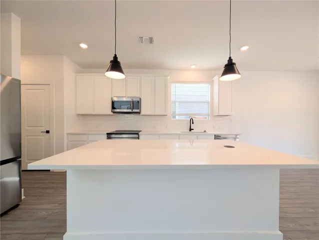 a view of kitchen with furniture and wooden floor