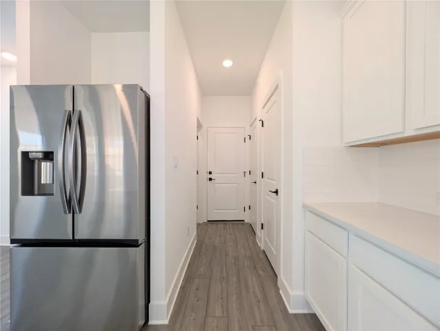 a kitchen with stainless steel appliances a sink a stove a microwave and white cabinets