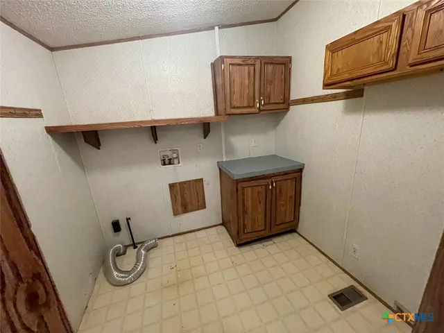 a kitchen with a refrigerator and cabinets