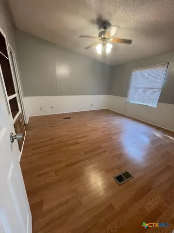 a view of a room with wooden floor