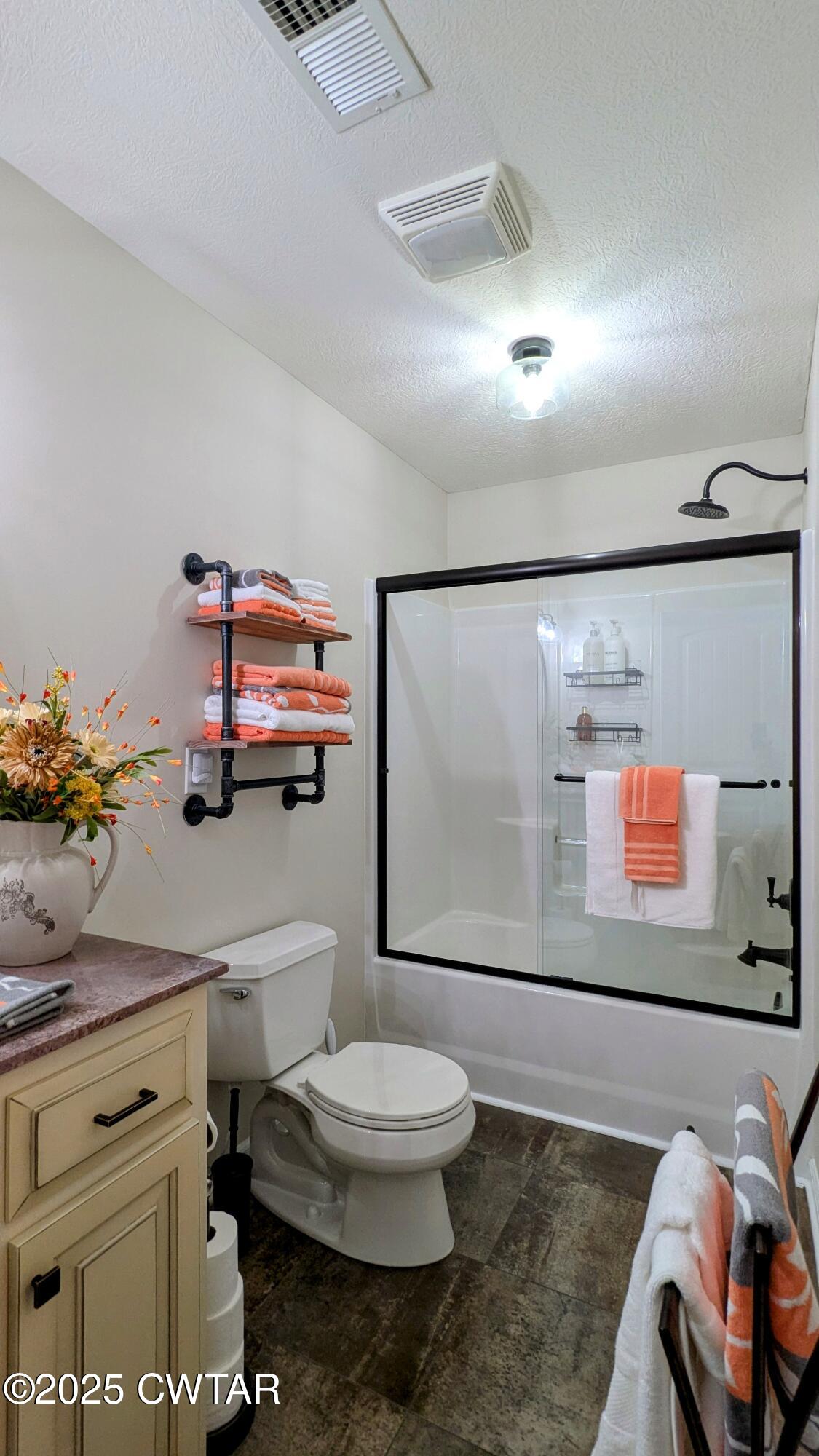 255 Ridgewood Drive Henderson, TN 38340 - Photo 12 of 25 a bathroom with a toilet sink and mirror