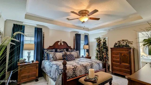 a bedroom with a bed and a chandelier