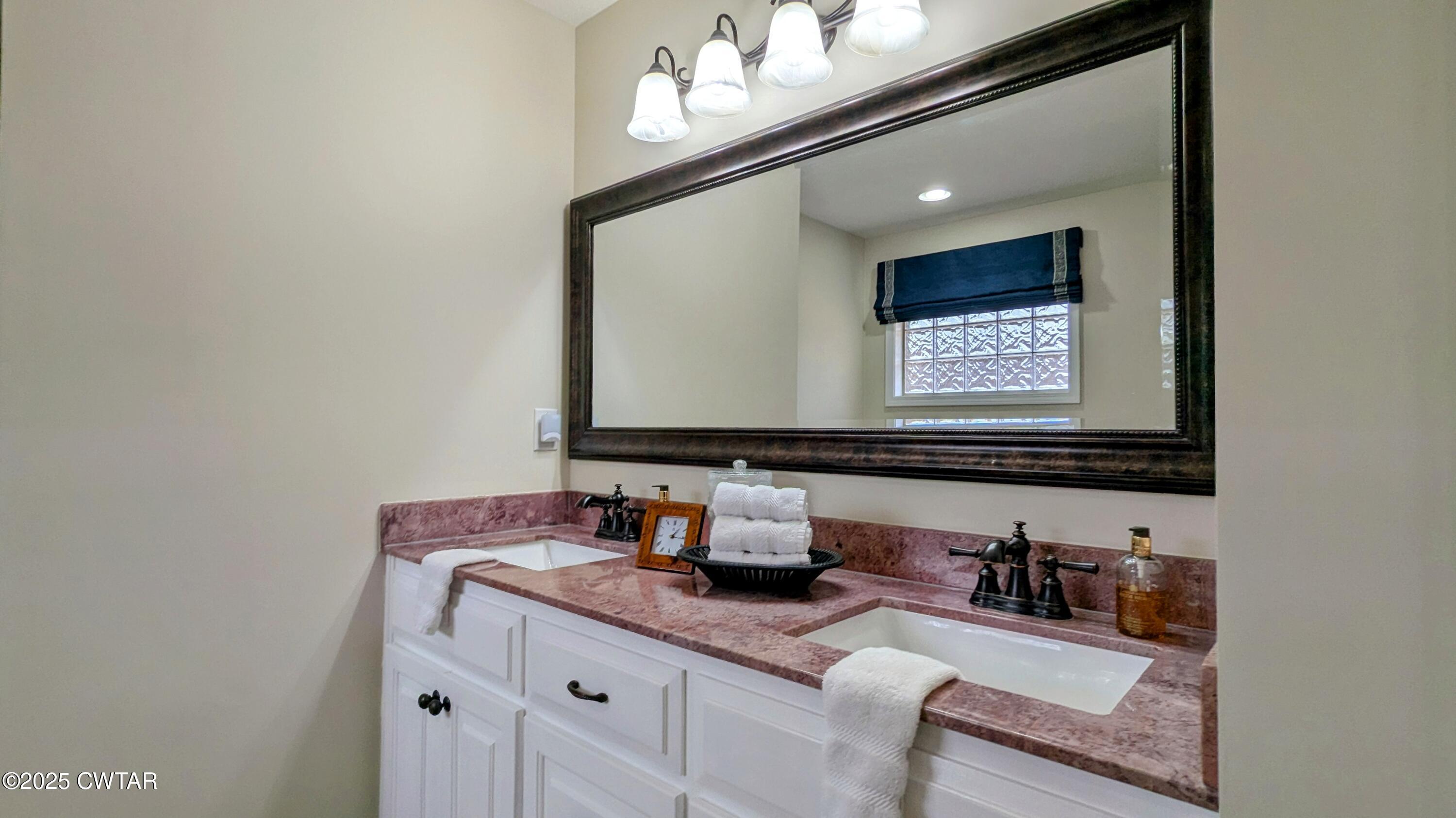 255 Ridgewood Drive Henderson, TN 38340 - Photo 15 of 25 a bathroom with a sink and a mirror