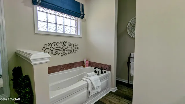 a bathroom with a bathtub and window