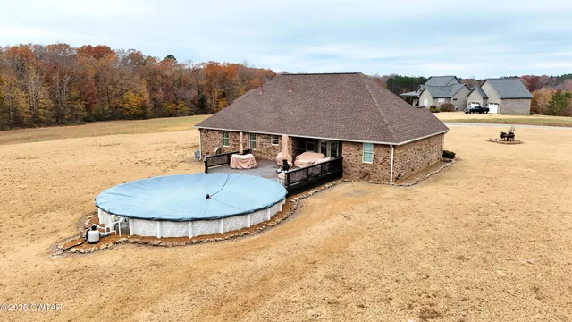 an aerial view of a house with table and chairs