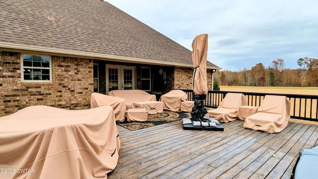 a view of a patio with a table chairs and a potted plant