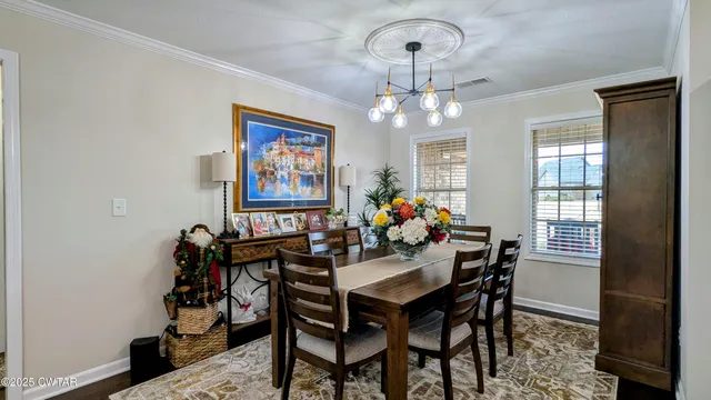 a view of a dining room with furniture and chandelier