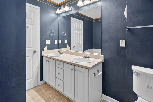 a bathroom with a sink a toilet and mirror