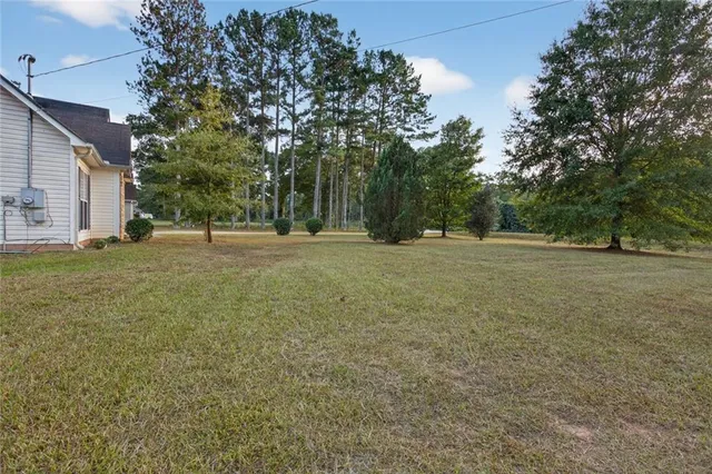 a big yard with lots of green space and trees