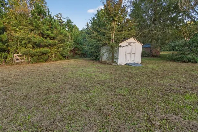a backyard of a house with a trees and barn