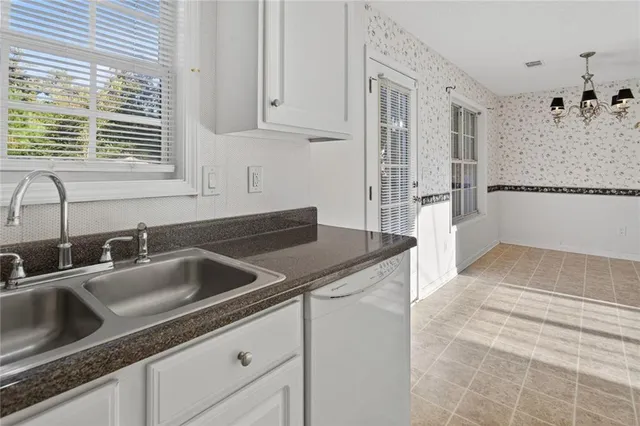 a kitchen with stainless steel appliances granite countertop a sink and a granite counter tops