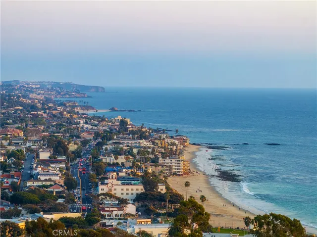 an aerial view of residential building and ocean view in back