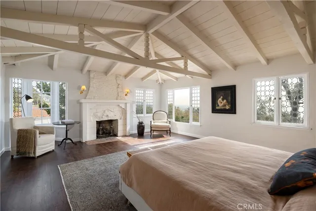 a spacious bedroom with a balcony a bed and a fireplace