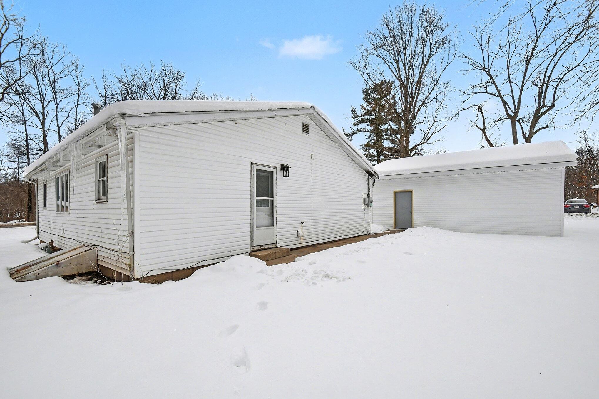 8172 East Emery Road New Carlisle, IN 46552 - Photo 11 of 14 a view of a white house with a large tree