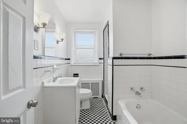 a bathroom with a sink a toilet and mirror