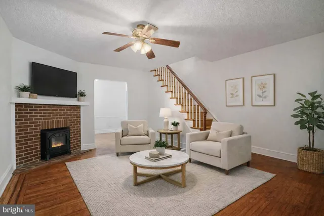 a living room with furniture a chandelier and a fireplace