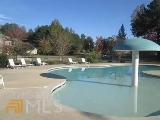 a view of a swimming pool with a patio