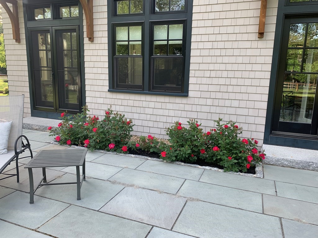 627 Bay Road Hamilton, MA 01982 - Photo 8 of 13 a view of a house with wooden bench and flowers