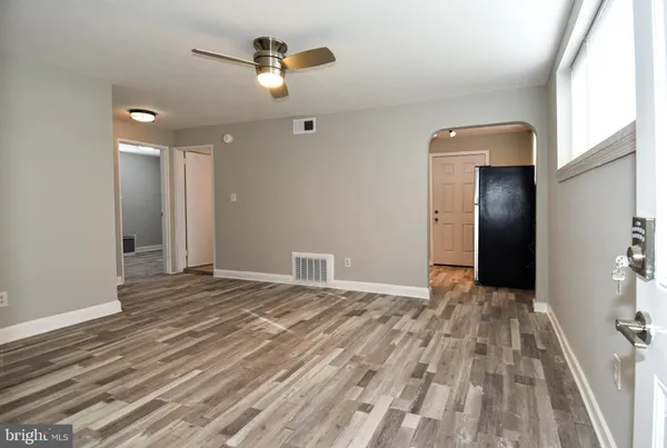 a view of an empty room with wooden floor