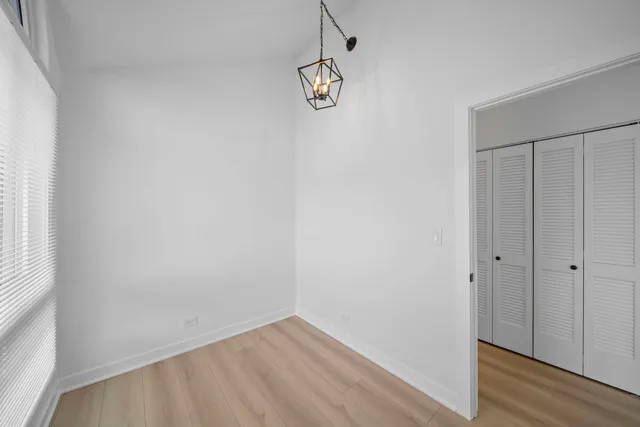 a view of a room with wooden floor and window