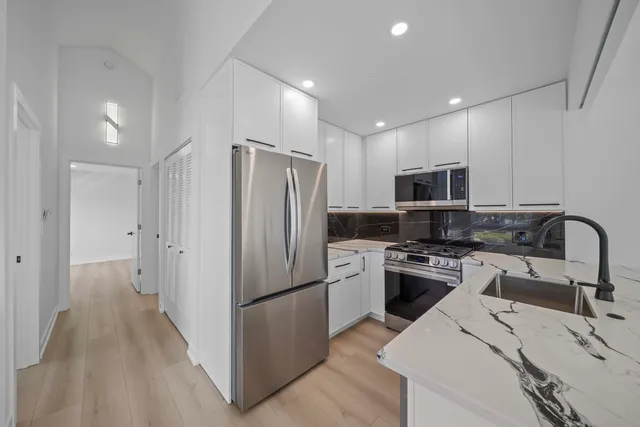 a kitchen with stainless steel appliances a refrigerator stove microwave and sink