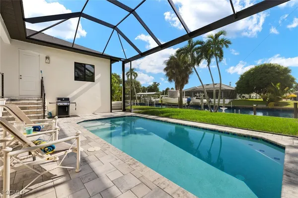 a view of a backyard with swimming pool